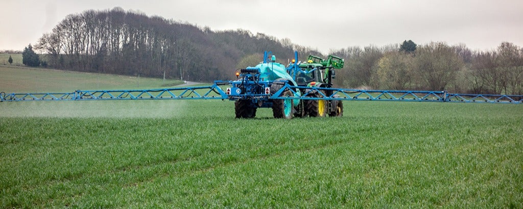 Tractor spraying fertilizer