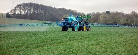 Tractor spraying fertilizer