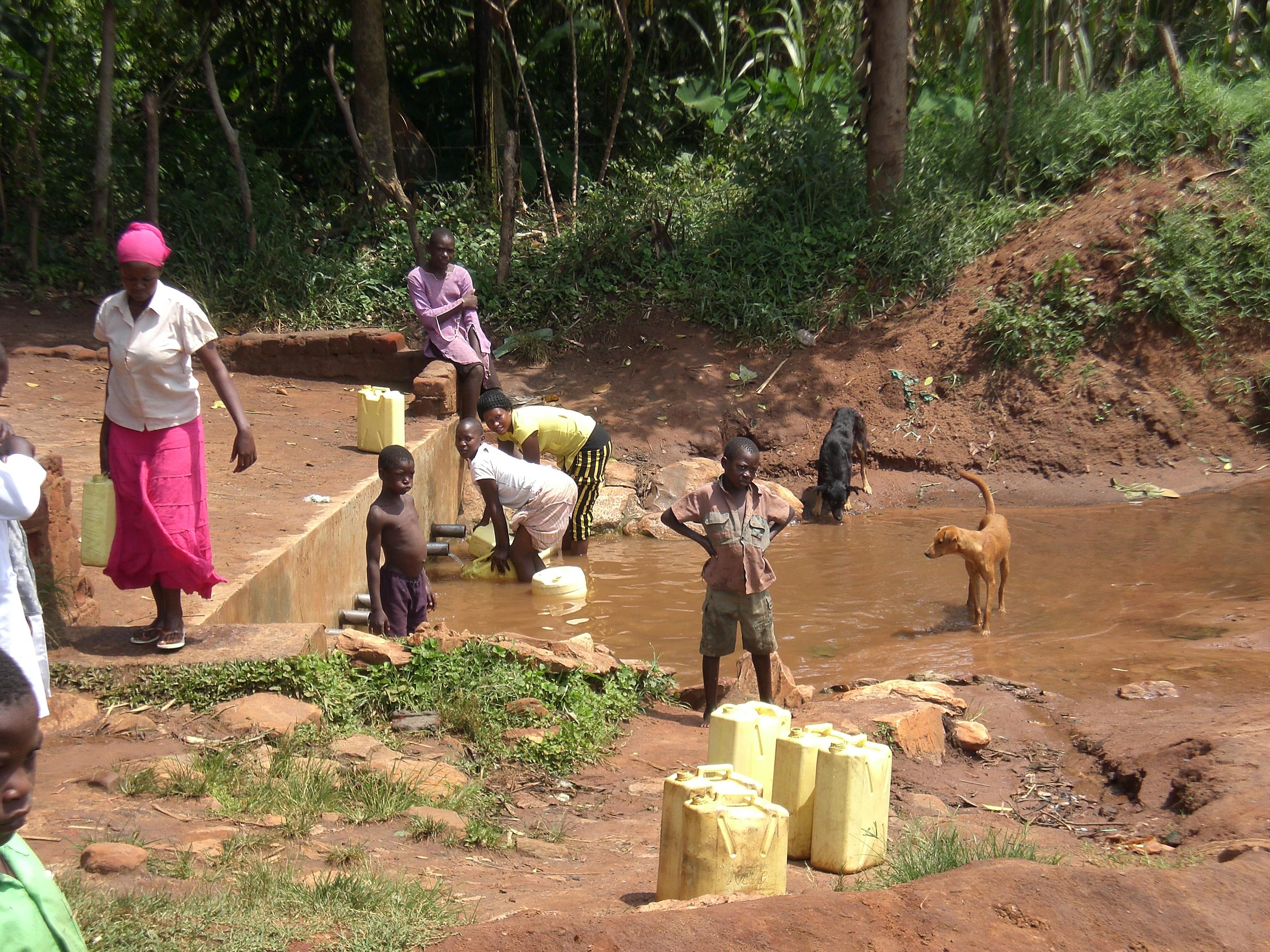 women and children collecting water in Africa