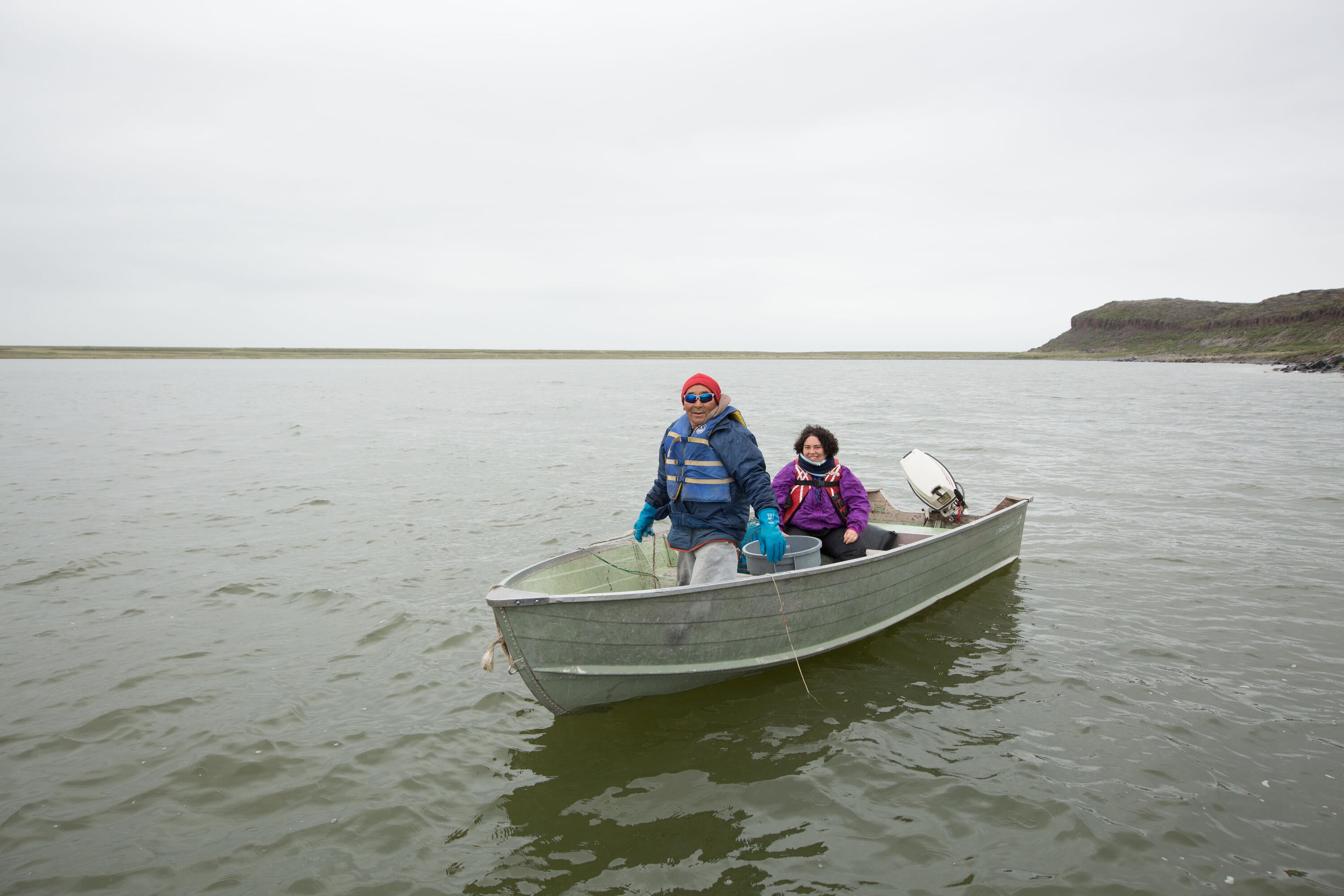 Spencer Weinstein and Kugluktuk, Nunavut community member in fishing boat
