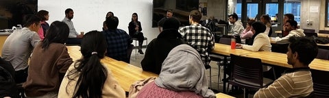 A group of students attending a panel Q and A event