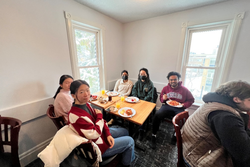 People sitting and smiling at a table with food