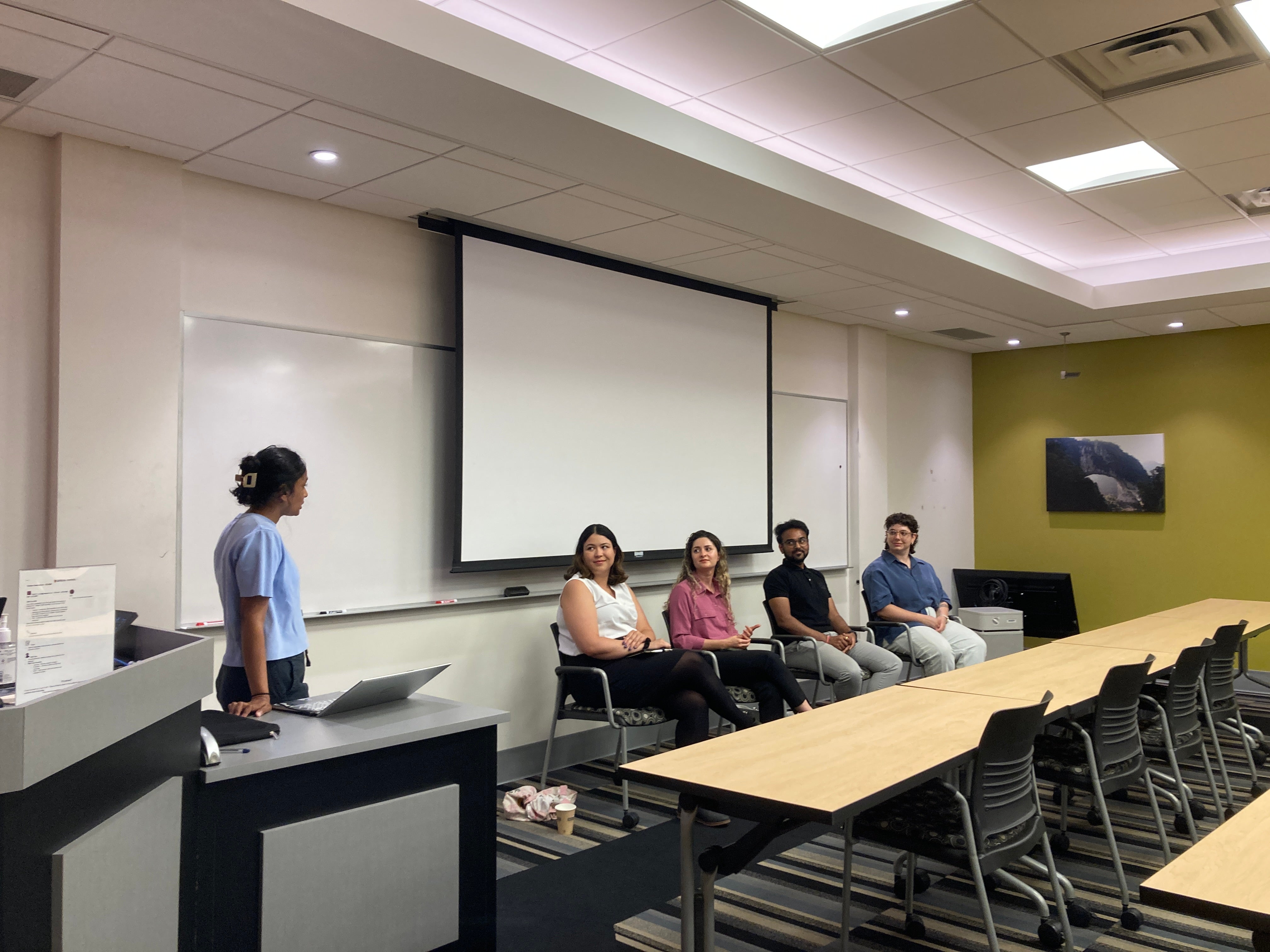 Room with students sitting next to tables at the career panel event