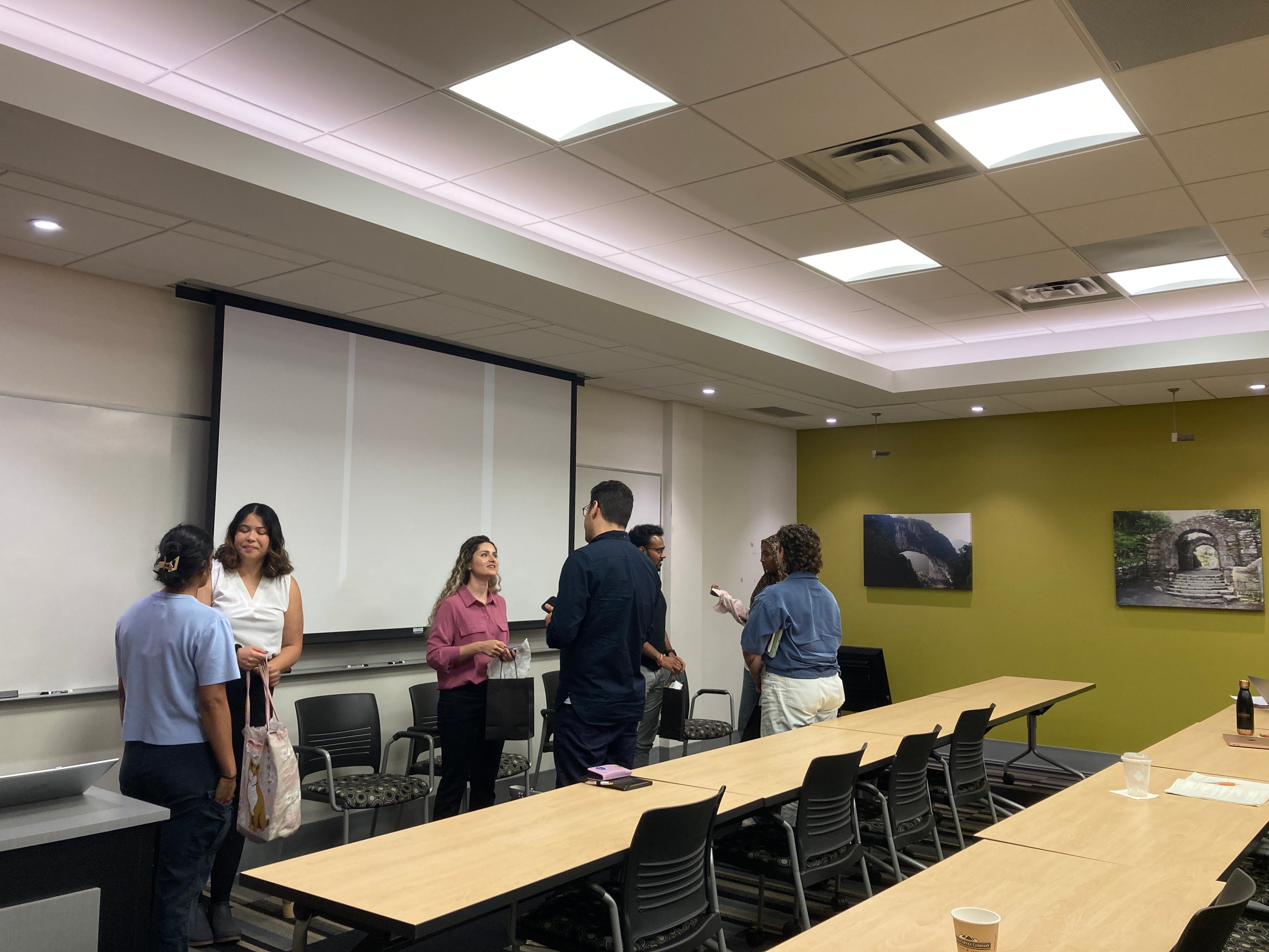 Room with students networking or talking with panelists