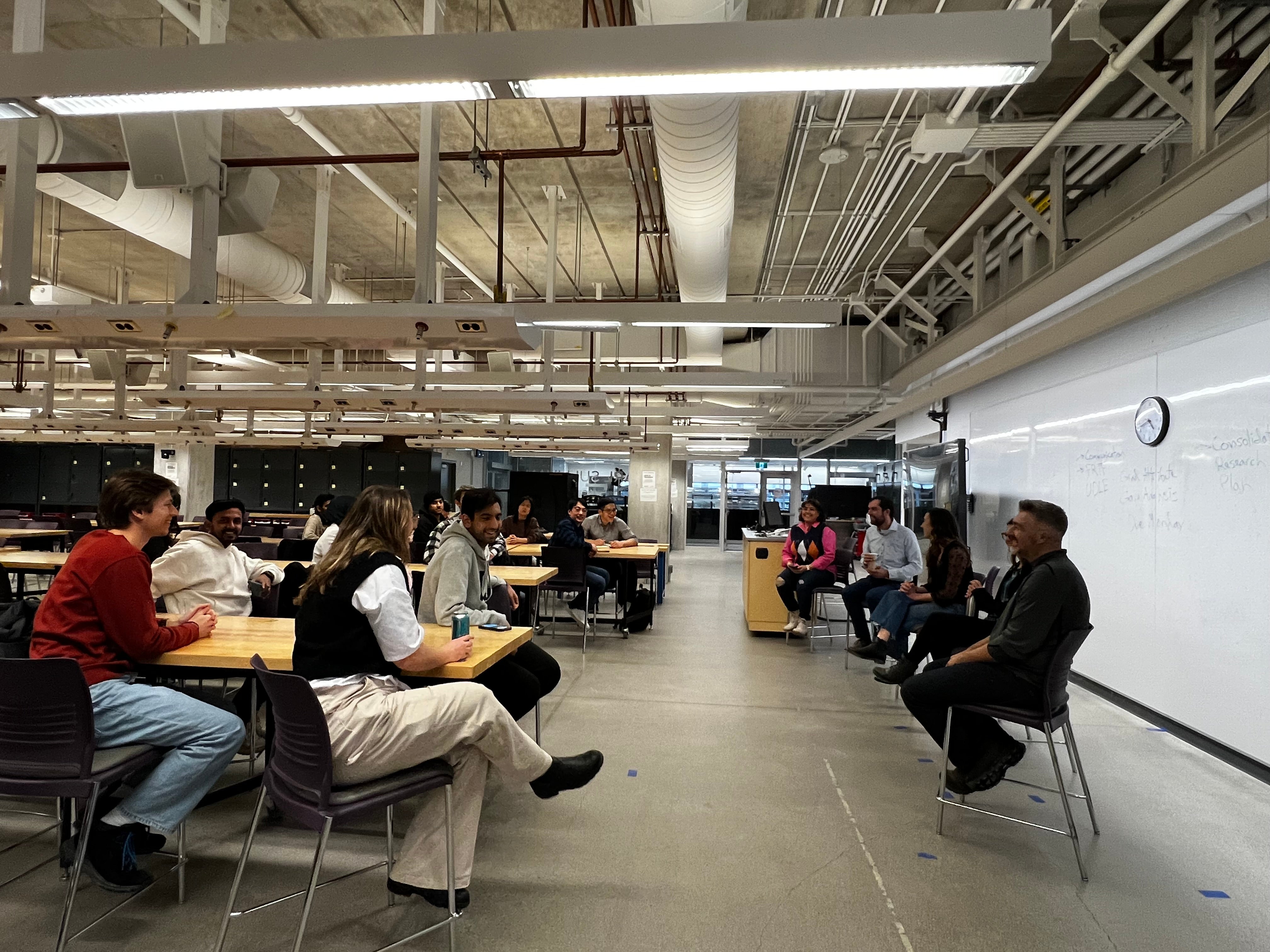 Image of the panel event organized, students sitting at tables listening to the panel