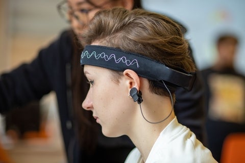 person with band around forehead for brain testing