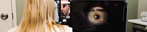 Optometrist taking digital image of patient's eye.