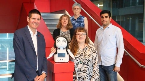 Researchers with robot
