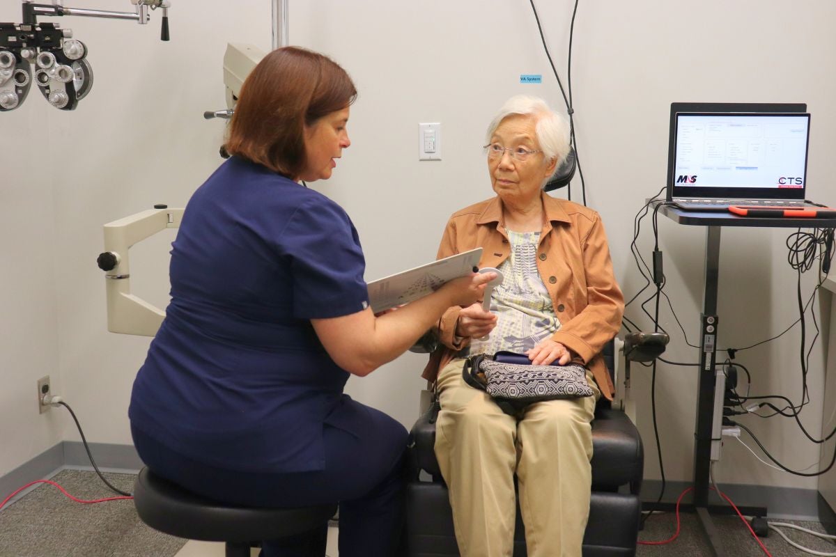 Dr. Tammy Labreche speaks to an older patient