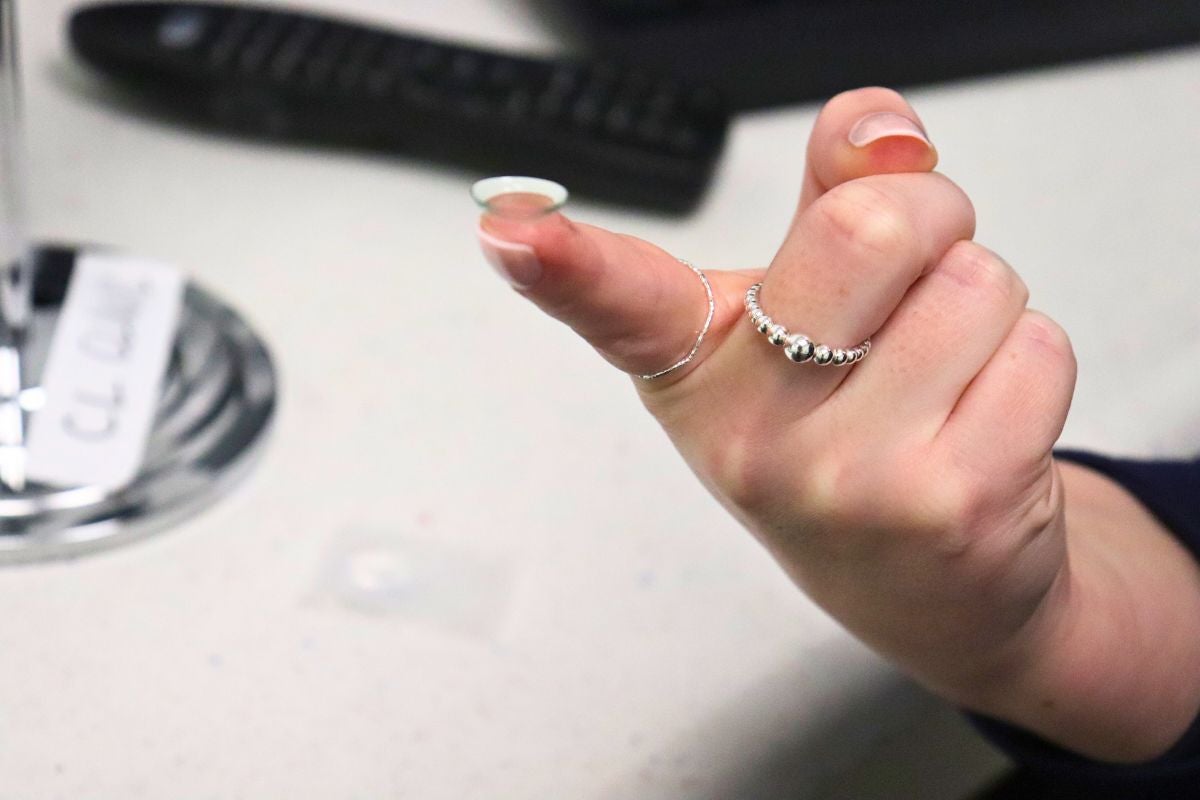 A single contact lens on the tip of a finger
