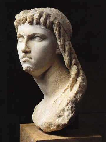 Marble bust of Cleopatra II or III shown from a left-front profile view, wearing a headdress with defined facial features.