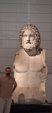 Dr. Porreca standing in front of marble Jupiter