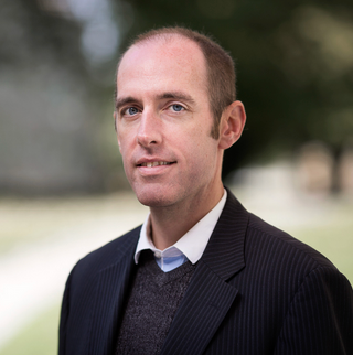 Dr. Andrew Faulkner smiling in a headshot
