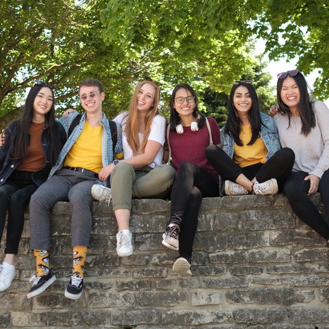 Group of undergraduate students posing for camera on campus