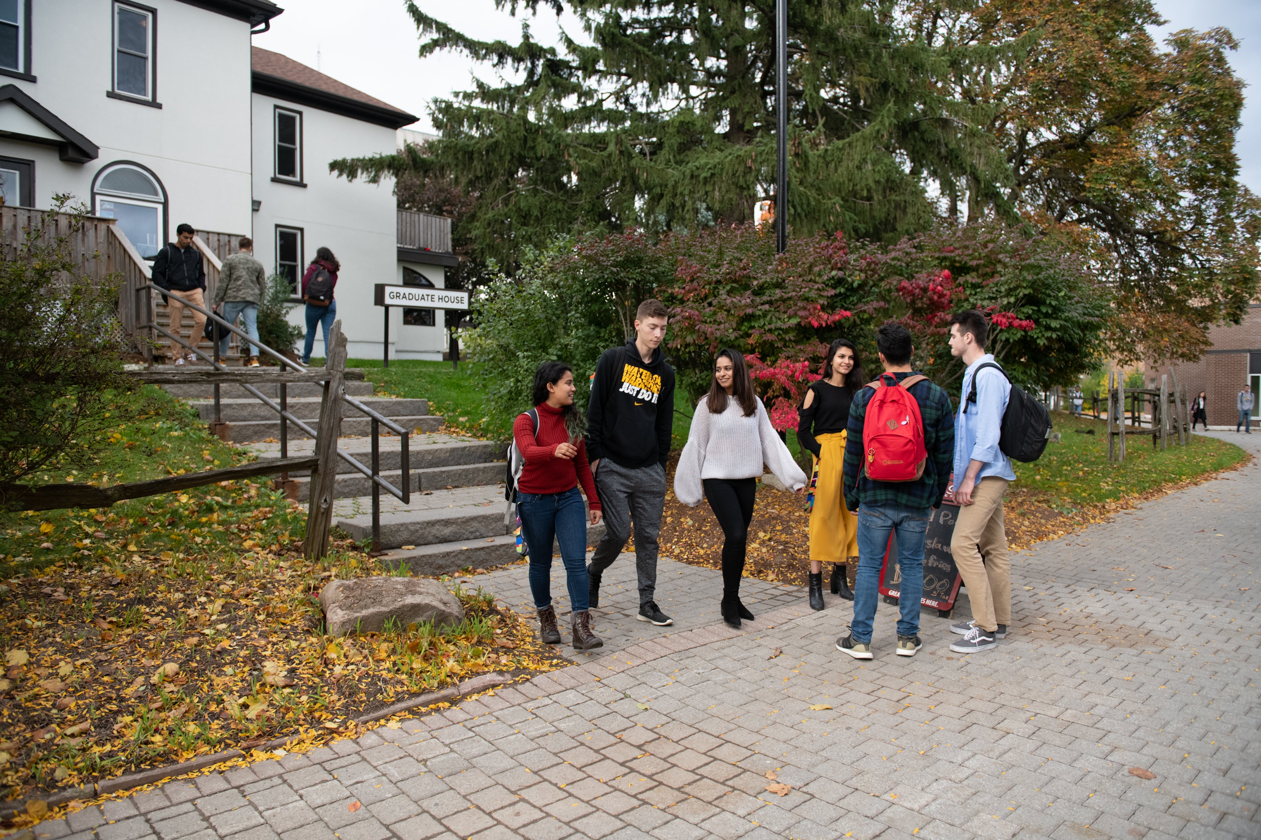 Students gather in front of Graduate House.