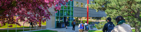 shot of campus, students walking in background