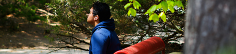 student eyes closed sitting on a bench