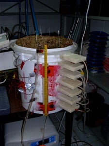 A bucket filled with peat and Sphagnum moss and instrumented with moisture sensors.