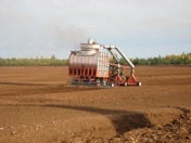 A vacuum-harvester extracting peat.