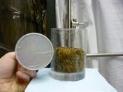 A porous disk and peat sample in appartus used to measure hydraulic properties.