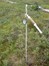 A long probe inserted into a peatland to sample gas and water in peat.
