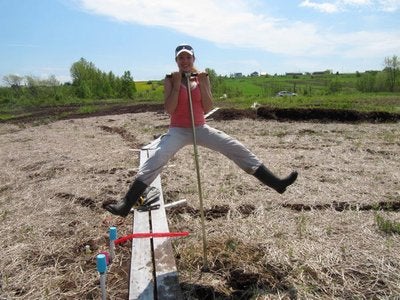 Sarah Scarlett balancing on a soil corer