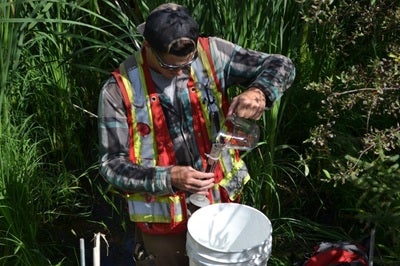  Researcher Corey calibrating a graduated cylinder