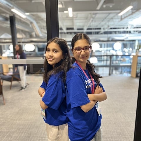Dynamic Duo Team Photo - two girls standing back to back