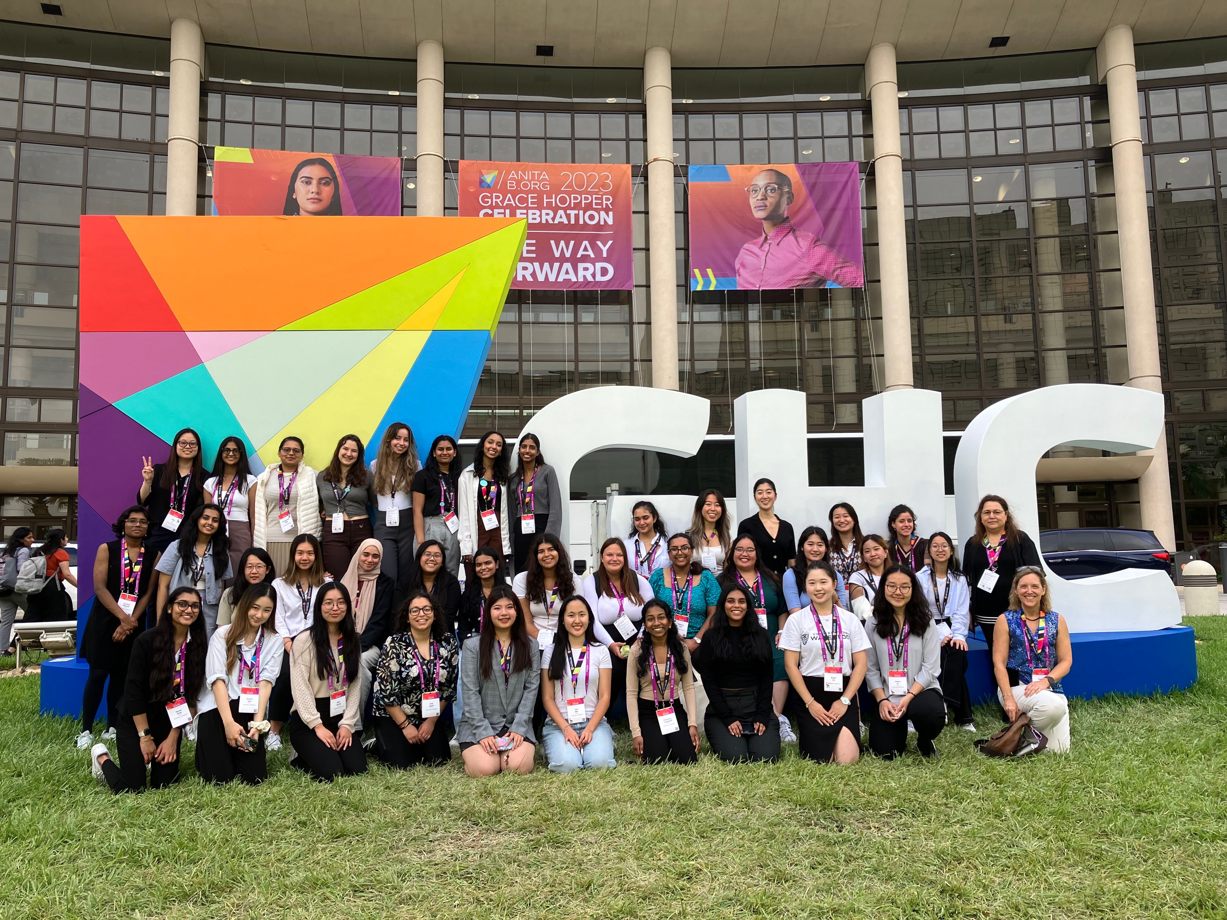 group photo of conference attendees, in front of a sign that reads Grace Hopper Celebration