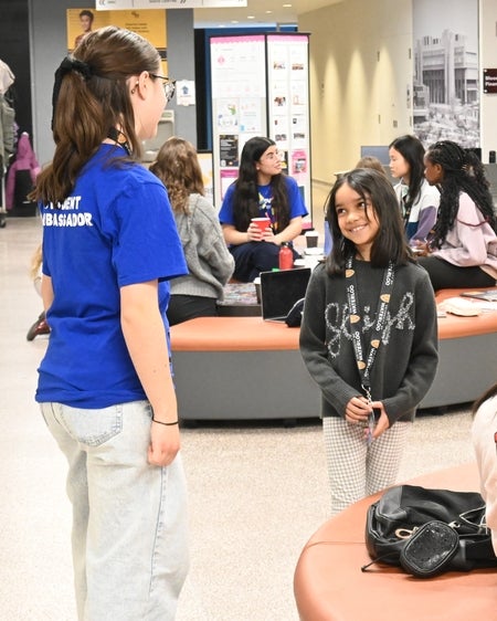 student ambassador talking to a smiling participant