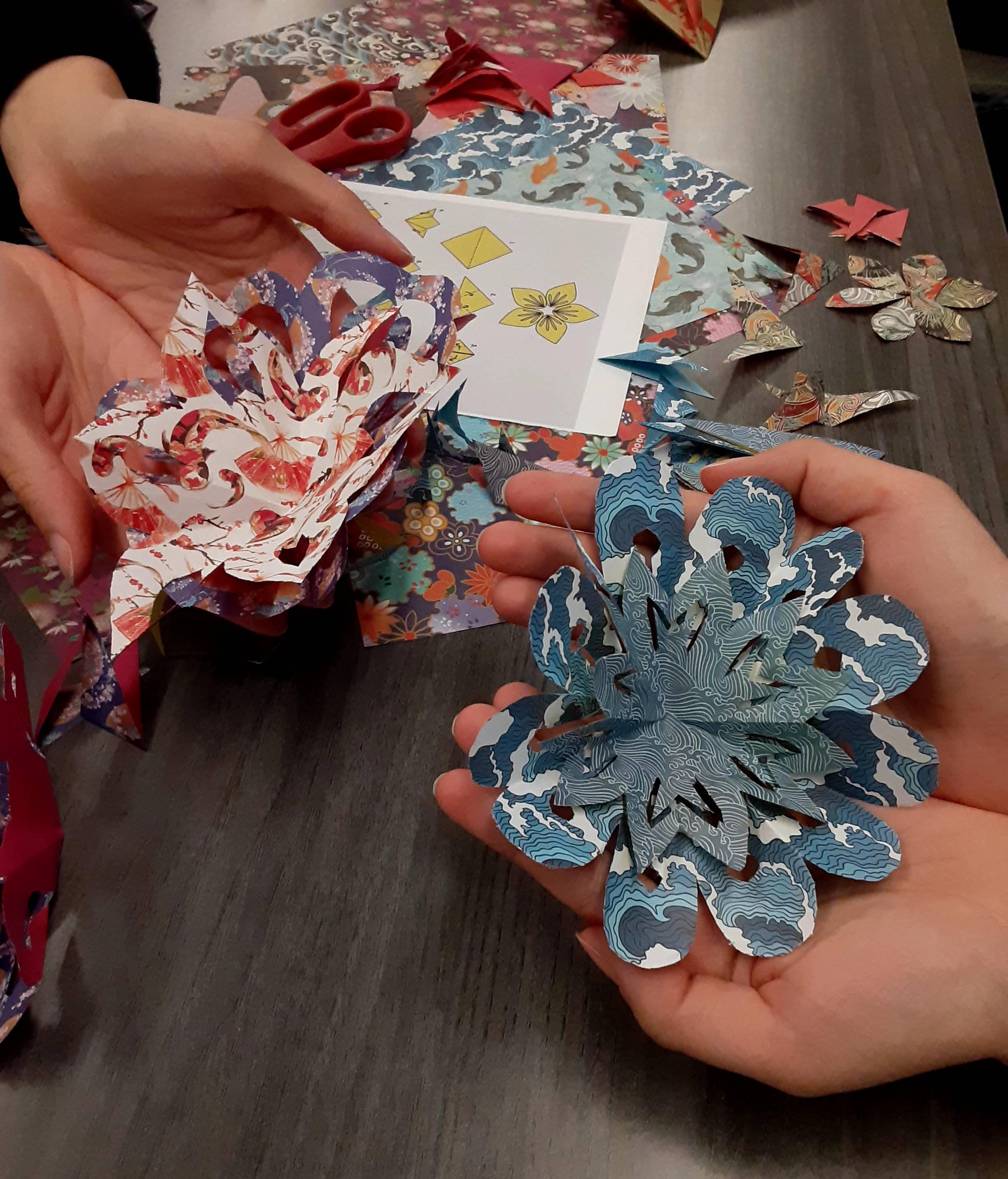 Participants holding paper flower cutouts