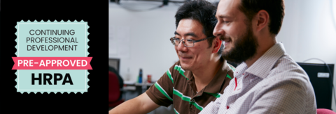 Two males looking at a computer