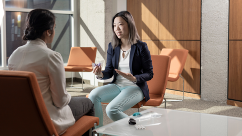 Employer chatting with student while sitting face to face