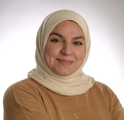 Ismaa in a cream headscarf and brown shirt