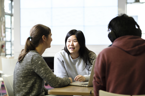 people talking at a desk