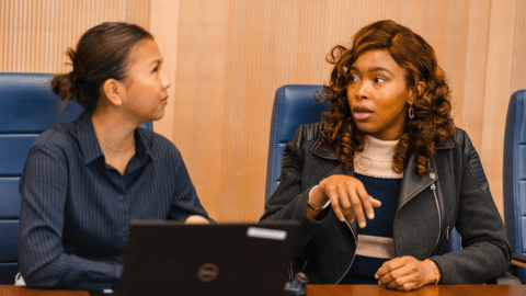 A co-op student talking to an advisor with a laptop