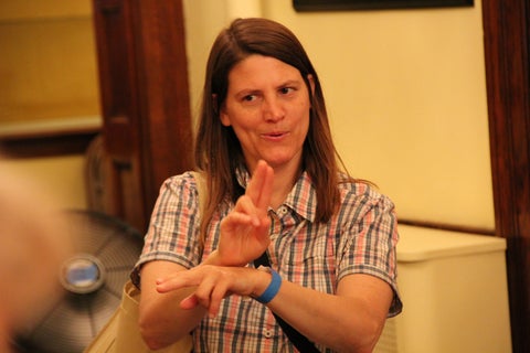 a woman communicates in sign language