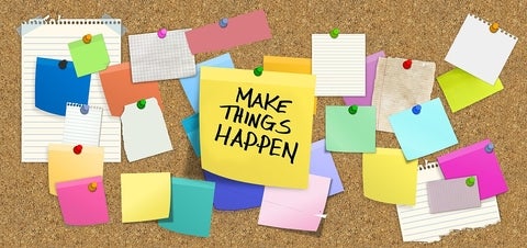 Colourful post-it notes decorate a cork board. The center post-it says "Make things happen" in capital letters.
