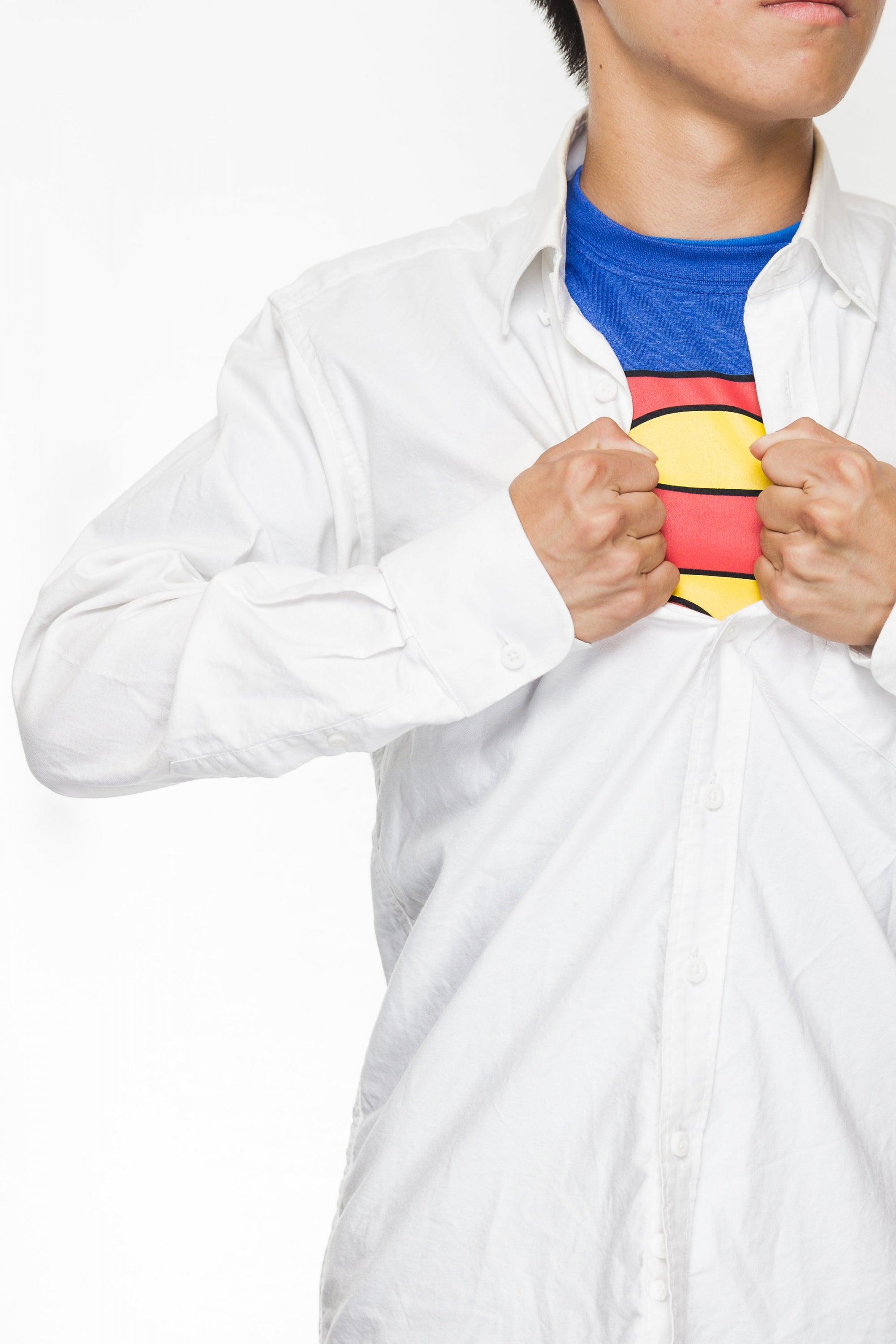 superhero revealing costume underneath a white dress shirt