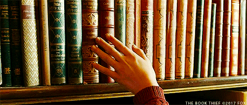 hand going across books gif