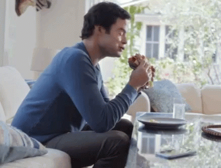 Gif of man eating a sandwich while saying 