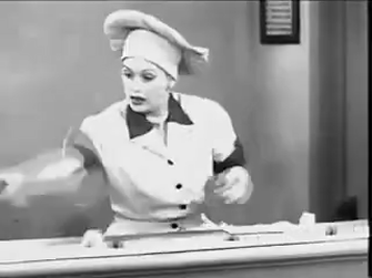 gif of Lucille Ball wrapping and eating chocolates in a factory setting