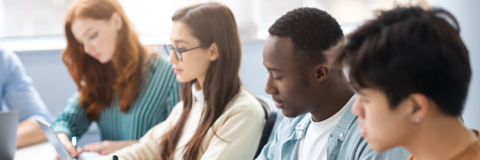 diverse college students taking notes