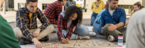 Diverse student activists prepare protest signs: youth engagement in social change